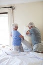 Senior couple having pillow fight on bed Royalty Free Stock Photo