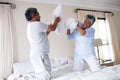 Senior couple having a pillow fight Royalty Free Stock Photo