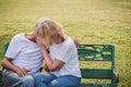 Senior couple having romantic time in a park, making out. Royalty Free Stock Photo