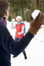 Senior Couple Having Snowball Fight In Snow Royalty Free Stock Photo