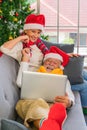 Senior couple having video call with family on laptop during Christmas eve Royalty Free Stock Photo