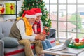 Senior couple having video call with family on laptop during Christmas eve Royalty Free Stock Photo