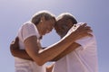 Senior couple head to head and embracing each other on beach Royalty Free Stock Photo