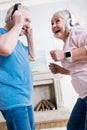 Senior couple in headphones dancing together at home Royalty Free Stock Photo