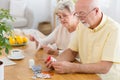 Senior couple with health problems reading leaflets of drugs