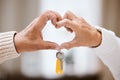 Senior couple, heart hands and keys for new home, success and bonding with love, care and support. Closeup, elderly