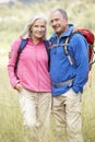 Senior Couple On Hike Through Beautiful Countryside Royalty Free Stock Photo