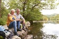 Senior Couple On Hike Sitting By River In UK Lake District Royalty Free Stock Photo