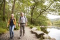 Senior Couple Hiking Along Path By River In UK Lake District Royalty Free Stock Photo