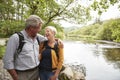 Senior Couple Hiking Along Path By River In UK Lake District Royalty Free Stock Photo