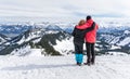 Senior couple is hiking in alpine snow winter mountains enjoying panorama view. Allgau, Bavaria, Germany. Royalty Free Stock Photo