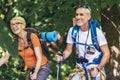 Couple hiking in forest wearing backpacks and hiking poles. Nordic walking, trekking. Healthy lifestyle Royalty Free Stock Photo