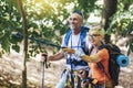 Couple hiking in forest wearing backpacks and hiking poles. Nordic walking, trekking. Healthy lifestyle Royalty Free Stock Photo