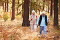 Senior couple hold hands hiking in a forest, California, USA Royalty Free Stock Photo