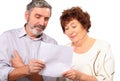 Senior couple hold paper list in hands