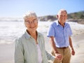 Senior, couple and holding hands on beach for portrait on retirement vacation or anniversary to relax with love, care Royalty Free Stock Photo