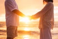Senior Couple Holding Hands Enjoying at Sunset Royalty Free Stock Photo