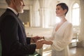 Senior Couple Holding Hands and Exchanging Wedding Vows in Church Royalty Free Stock Photo