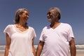 Senior couple holding hands and looking each other on beach Royalty Free Stock Photo