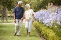 Senior Couple Holding Hands On Romantic Walk In Park Together Royalty Free Stock Photo