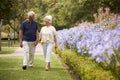 Senior Couple Holding Hands On Romantic Walk In Park Together Royalty Free Stock Photo