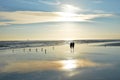 Senior couple holding hands walking on beach enjoying sunrise. Royalty Free Stock Photo
