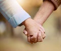 Senior couple, holding hands and walking in nature to bond in the countryside for love, care and affection. Retirement Royalty Free Stock Photo