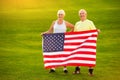 Senior couple holding US flag. Royalty Free Stock Photo