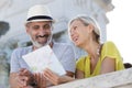 senior couple on holiday laughing togather while looking at map Royalty Free Stock Photo