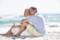 Senior Couple On Holiday Sitting On Sandy Beach Royalty Free Stock Photo