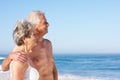 Senior Couple On Holiday Walking Along Sandy Beach Royalty Free Stock Photo