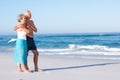 Senior Couple On Holiday Walking Along Sandy Beach Royalty Free Stock Photo
