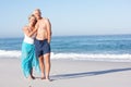 Senior Couple On Holiday Walking Along Sandy Beach Royalty Free Stock Photo