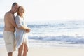 Senior Couple On Holiday Walking Along Sandy Beach Royalty Free Stock Photo