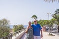 Senior couple on holidays walking near the sea in summer season - happy mature people in retired lifestyle relax outdoor leisure Royalty Free Stock Photo