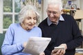 Senior Couple At Home With Bills Checking Home Finances Royalty Free Stock Photo