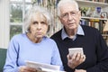 Senior Couple At Home With Bills Worried About Home Finances Royalty Free Stock Photo