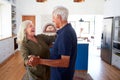 Senior Couple At Home Dancing In Kitchen Together Royalty Free Stock Photo