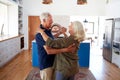 Senior Couple At Home Dancing In Kitchen Together Royalty Free Stock Photo
