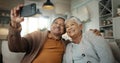 Senior couple, home and selfie while laughing on sofa and enjoying retirement together. Phone, smile and happy Royalty Free Stock Photo