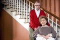 Senior couple at home, woman in wheelchair