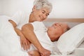 Senior couple, hug and communication in bed, relaxing and love in retirement for bonding on weekend. Happy elderly Royalty Free Stock Photo