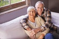 Senior couple, hug and portrait on couch with smile, love and connection in living room for retirement. Elderly woman Royalty Free Stock Photo