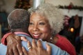 Senior Couple Hugging As They Celebrate Christmas At Home Together Royalty Free Stock Photo