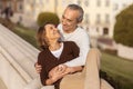 Senior Couple Hugging Outside, Posing Wrapped In Each Other's Arms