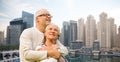 Senior couple hugging over dubai city waterfront