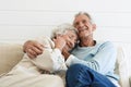 Senior Couple Hugging on Sofa Royalty Free Stock Photo