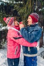 Senior couple hugging in winter forest. Man and woman walking outdoors on Valentine`s Day Royalty Free Stock Photo