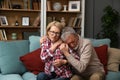 Senior couple husband and wife man and woman, hugs seriously ill woman for support feels her pain regrets her health problem Royalty Free Stock Photo