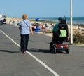 Senior couple. Independence with disability. Mobility scooters.